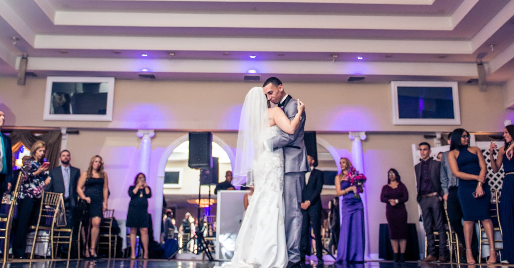 a couple dancing in front of a crowd