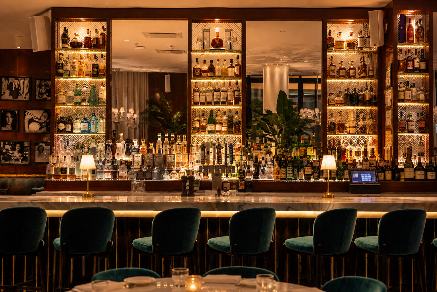 a bar with shelves of liquor and chairs
