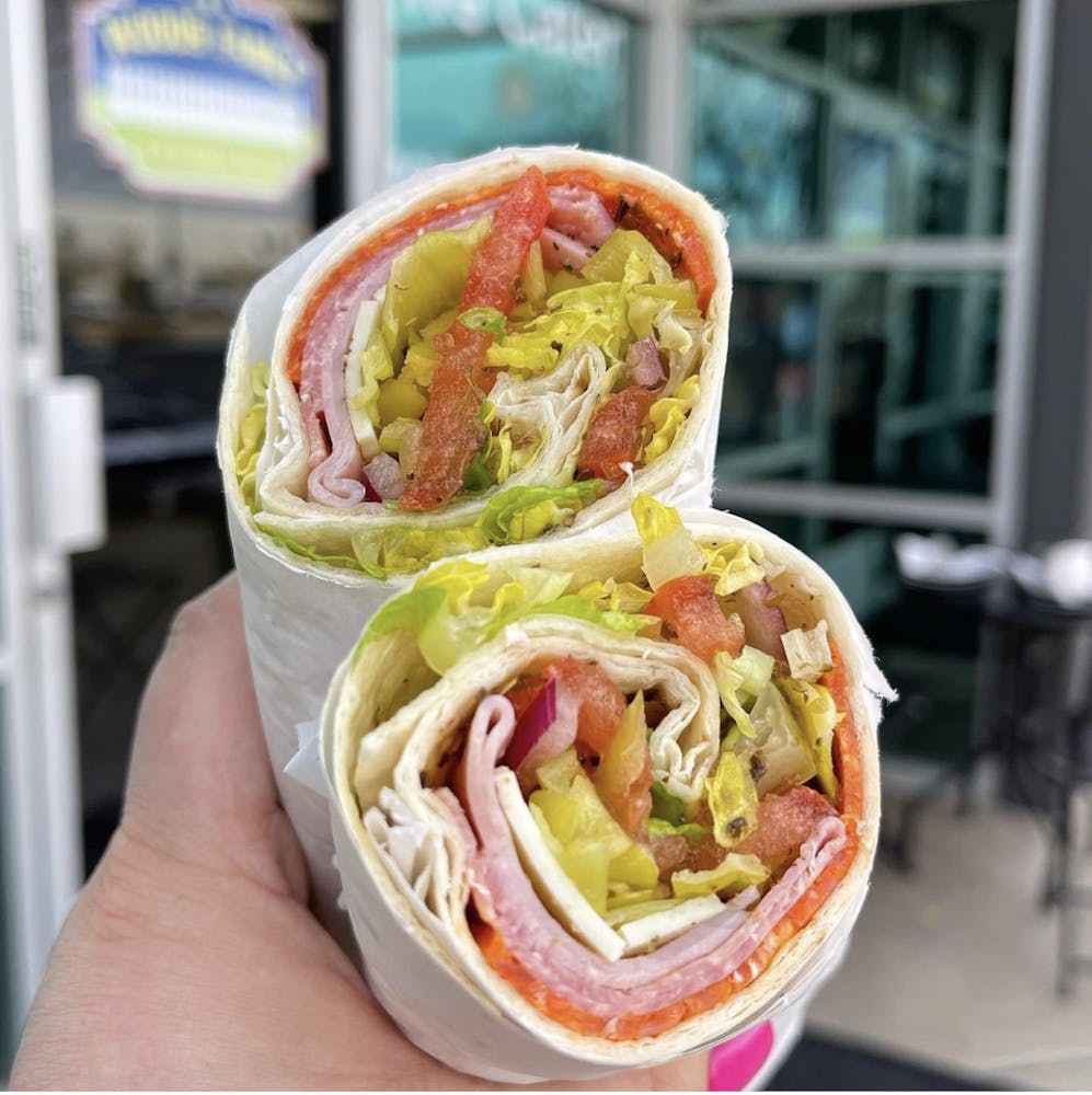 a close up of a person holding a hot dog