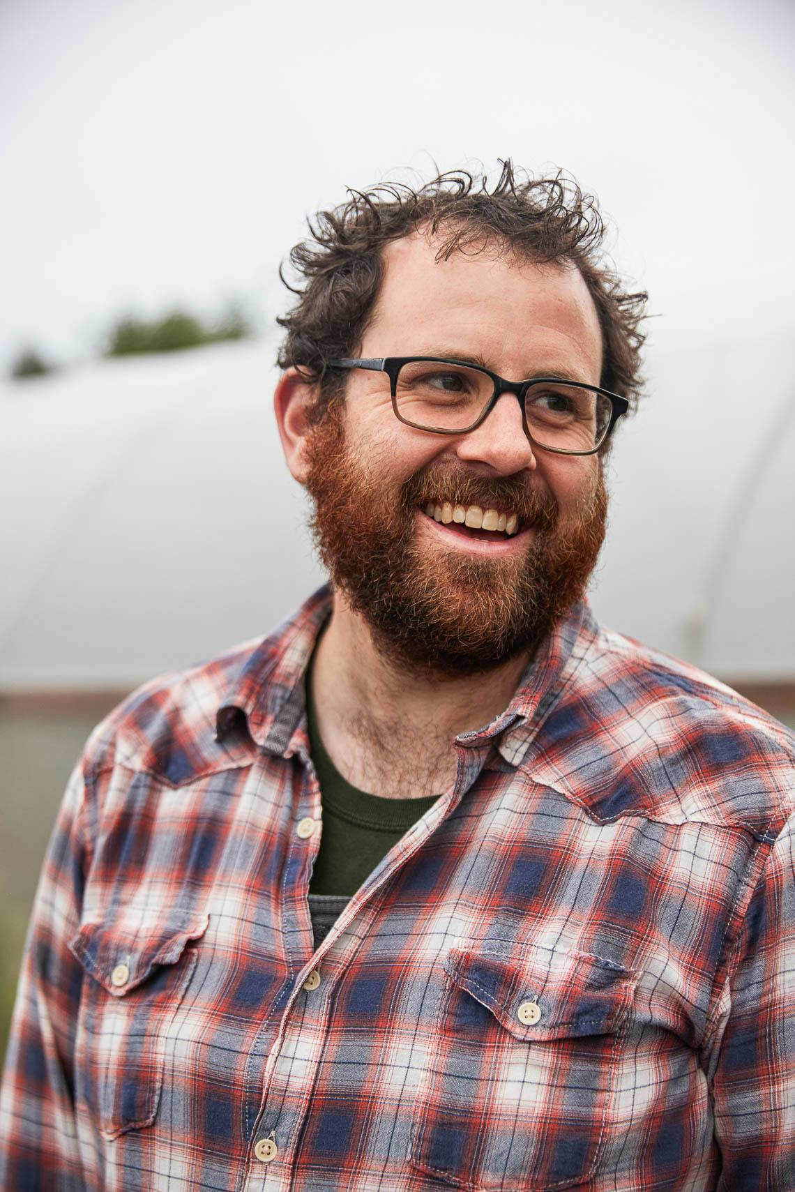 a man wearing glasses and looking at the camera