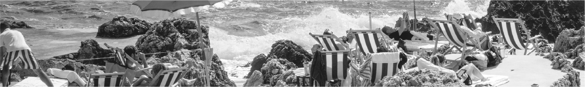 a man sitting in a chair at the beach