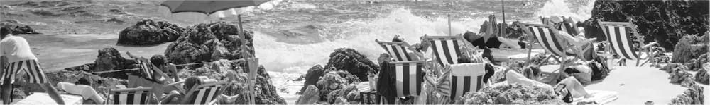 a man sitting in a chair at the beach