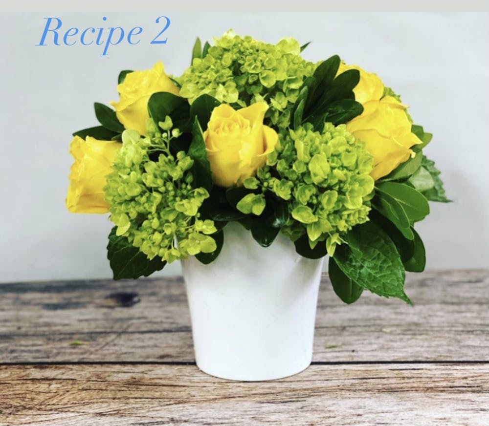 a bouquet of flowers in a vase on a table