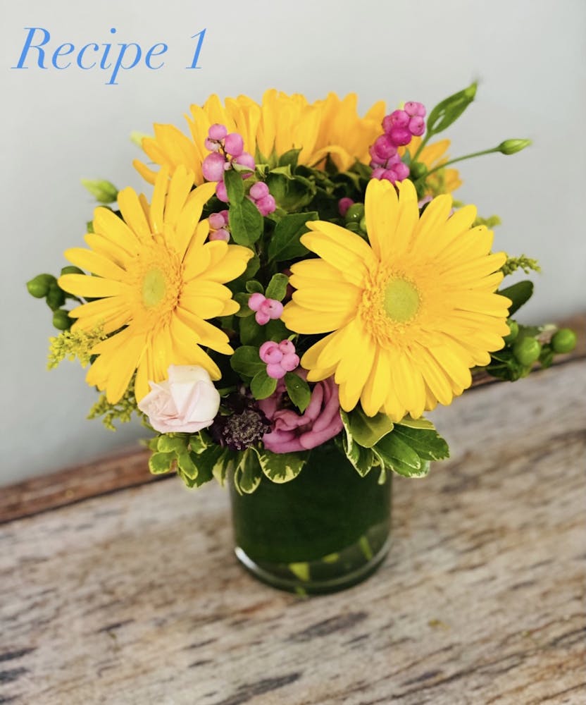 a bouquet of flowers in a vase on a table