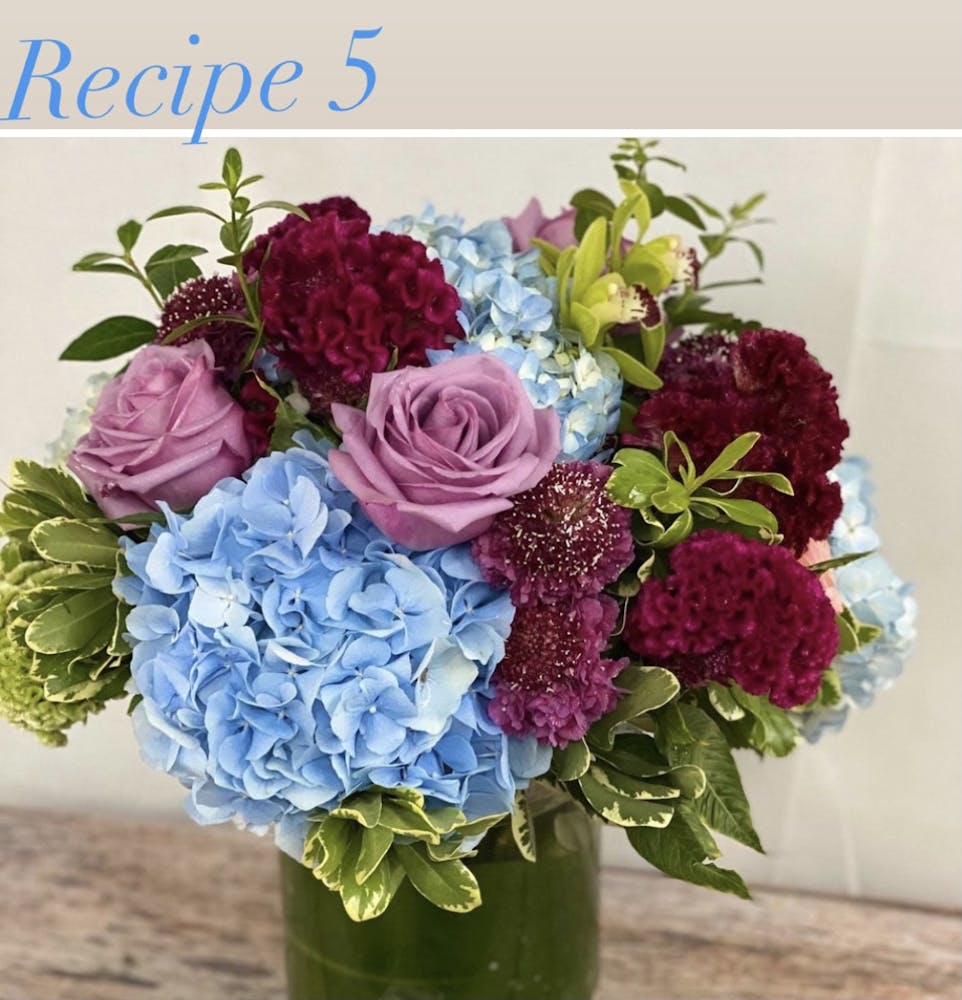 a bouquet of flowers in a vase on a table