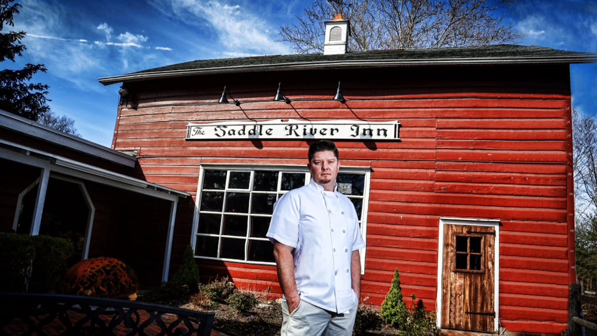 a man standing in front of a house