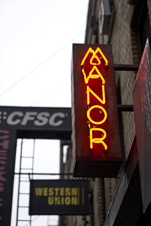 a sign hanging off the side of a building