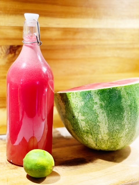 a close up of a bottle on a wooden table