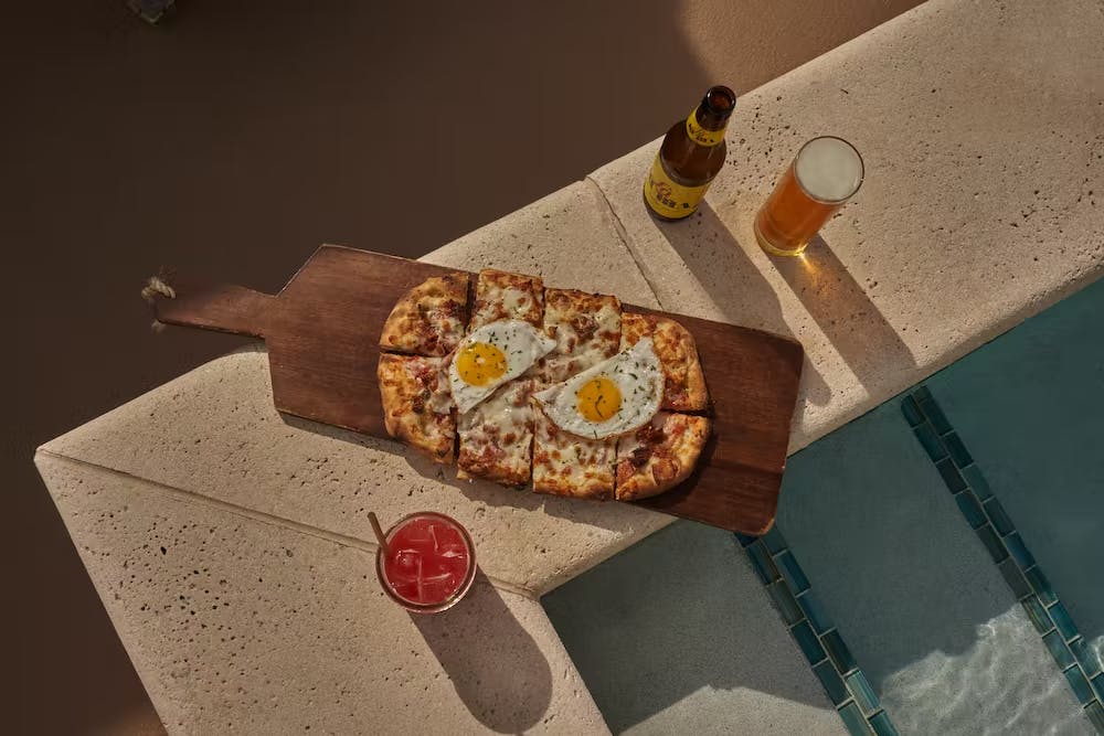 a slice of pizza sitting on top of a wooden table