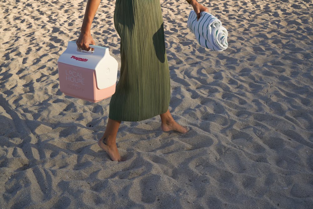 a person that is standing in the sand