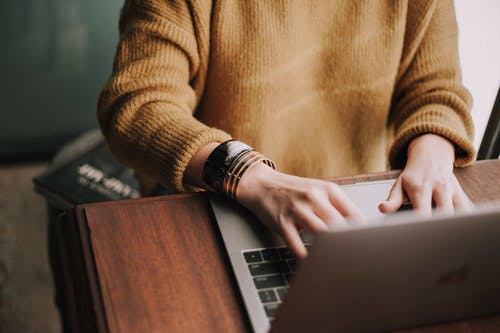 a man sitting at a table using a laptop