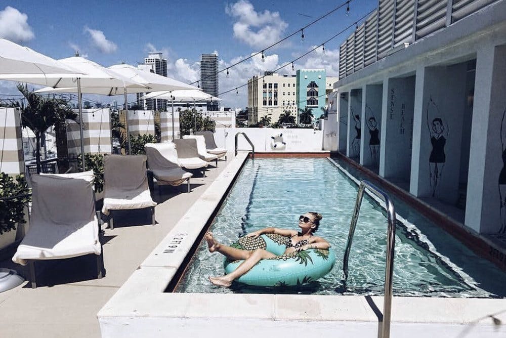 a person sitting on a bench in front of a building