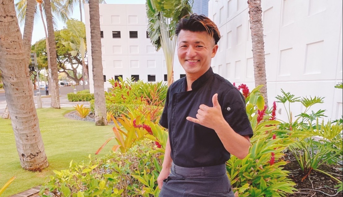 a young boy standing in a garden