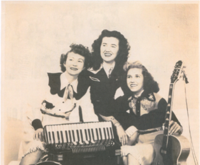 a group of women posing with musical instruments