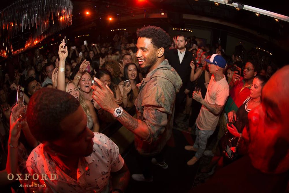 Trey Songz et al. standing in front of a crowd
