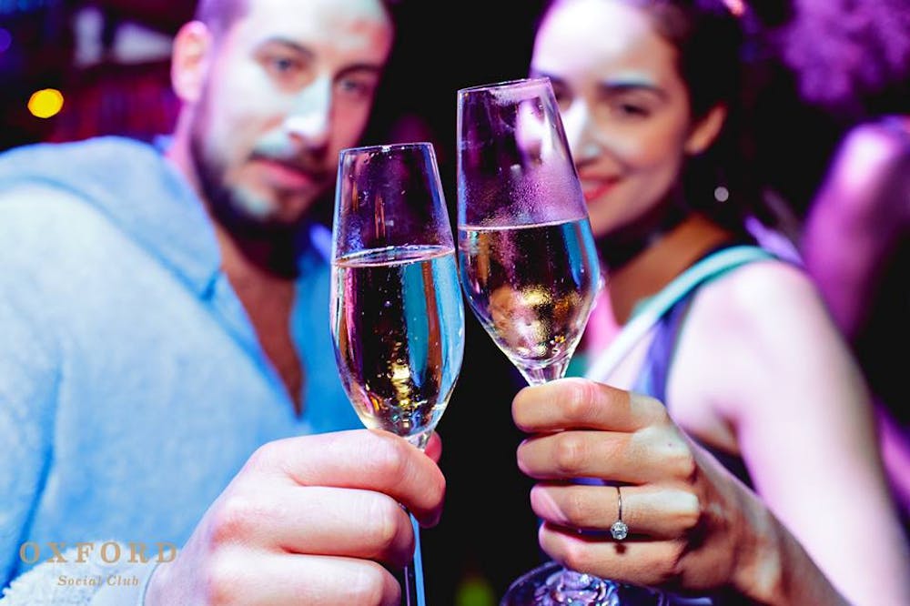 a close up of a person holding a wine glass