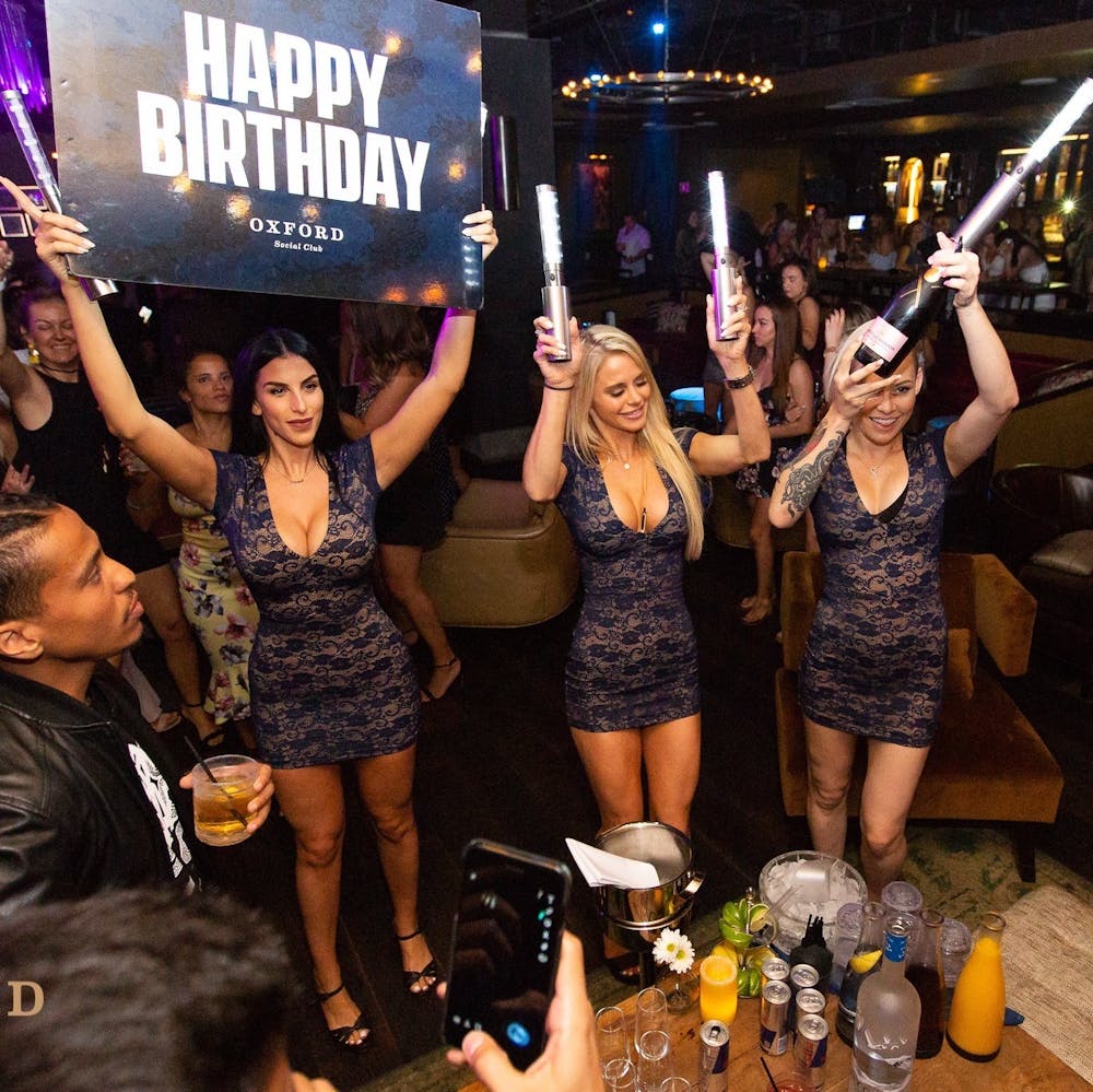 a group of people standing in front of a crowd posing for the camera
