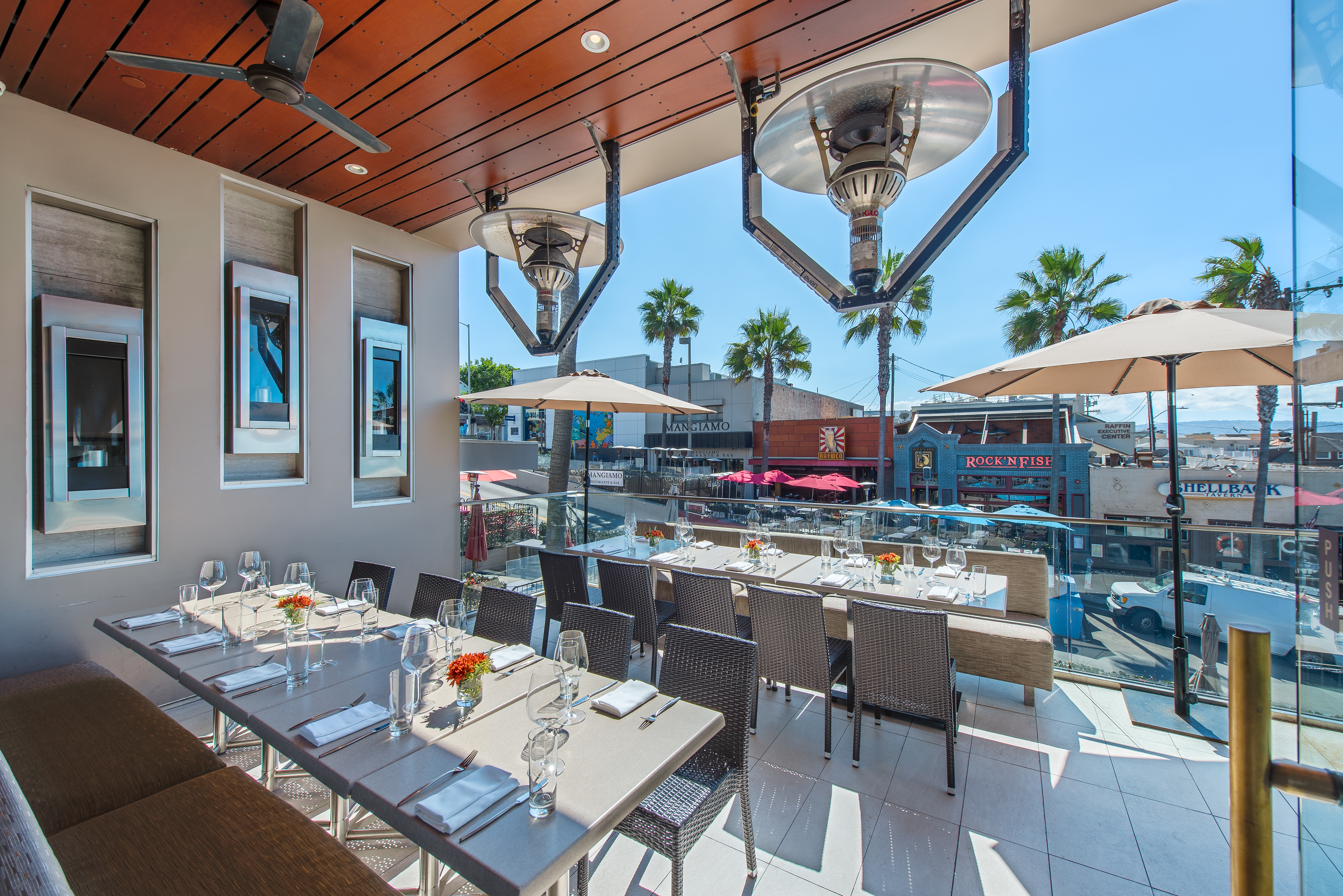 a group of people sitting at a table in front of a building