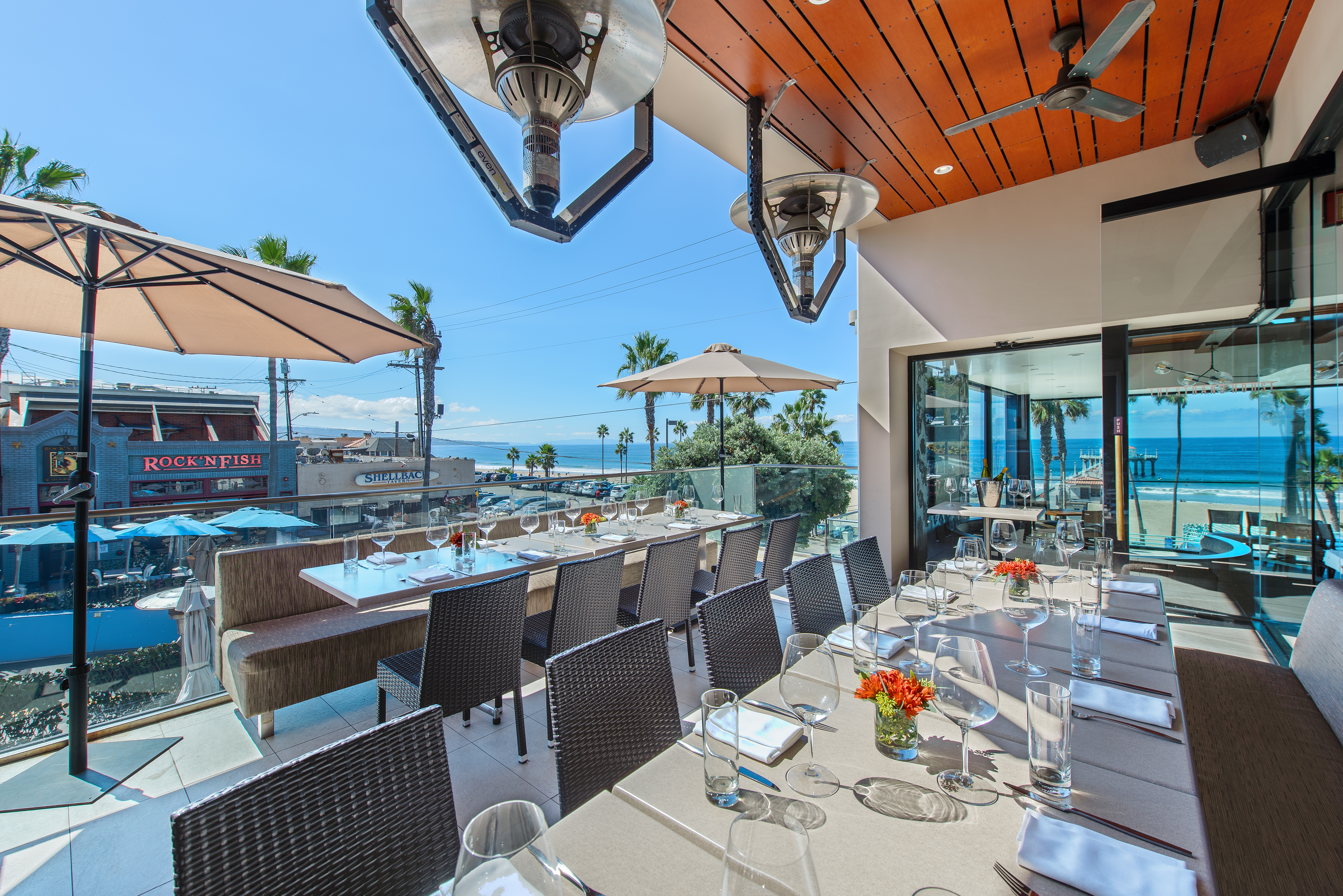a group of people sitting at a table in front of a building
