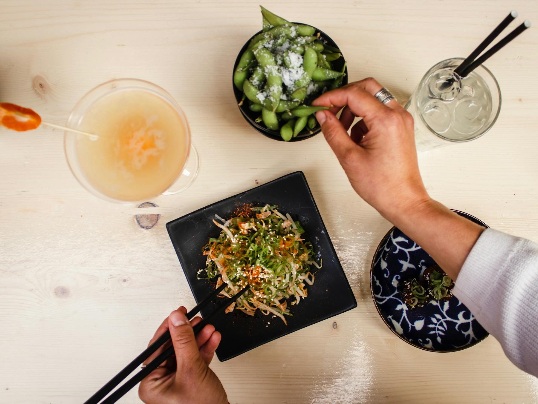 a person eating with chopsticks
