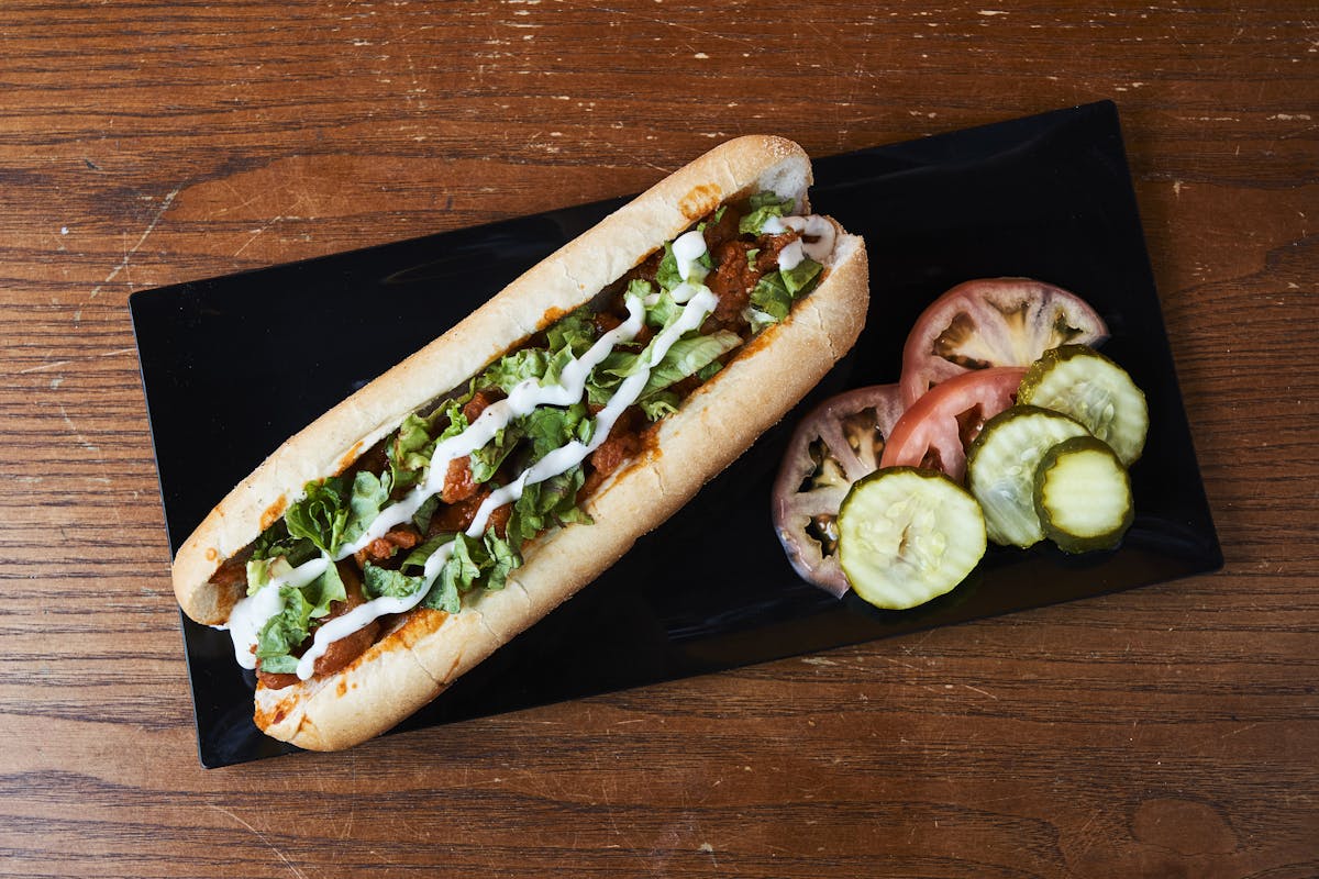 a hot dog on a wooden table
