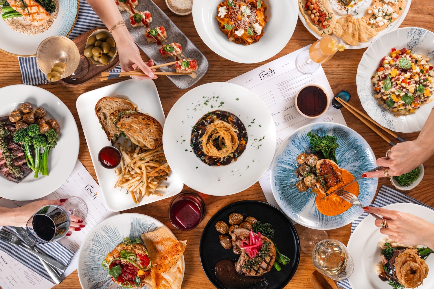 a table with plates of food and drinks