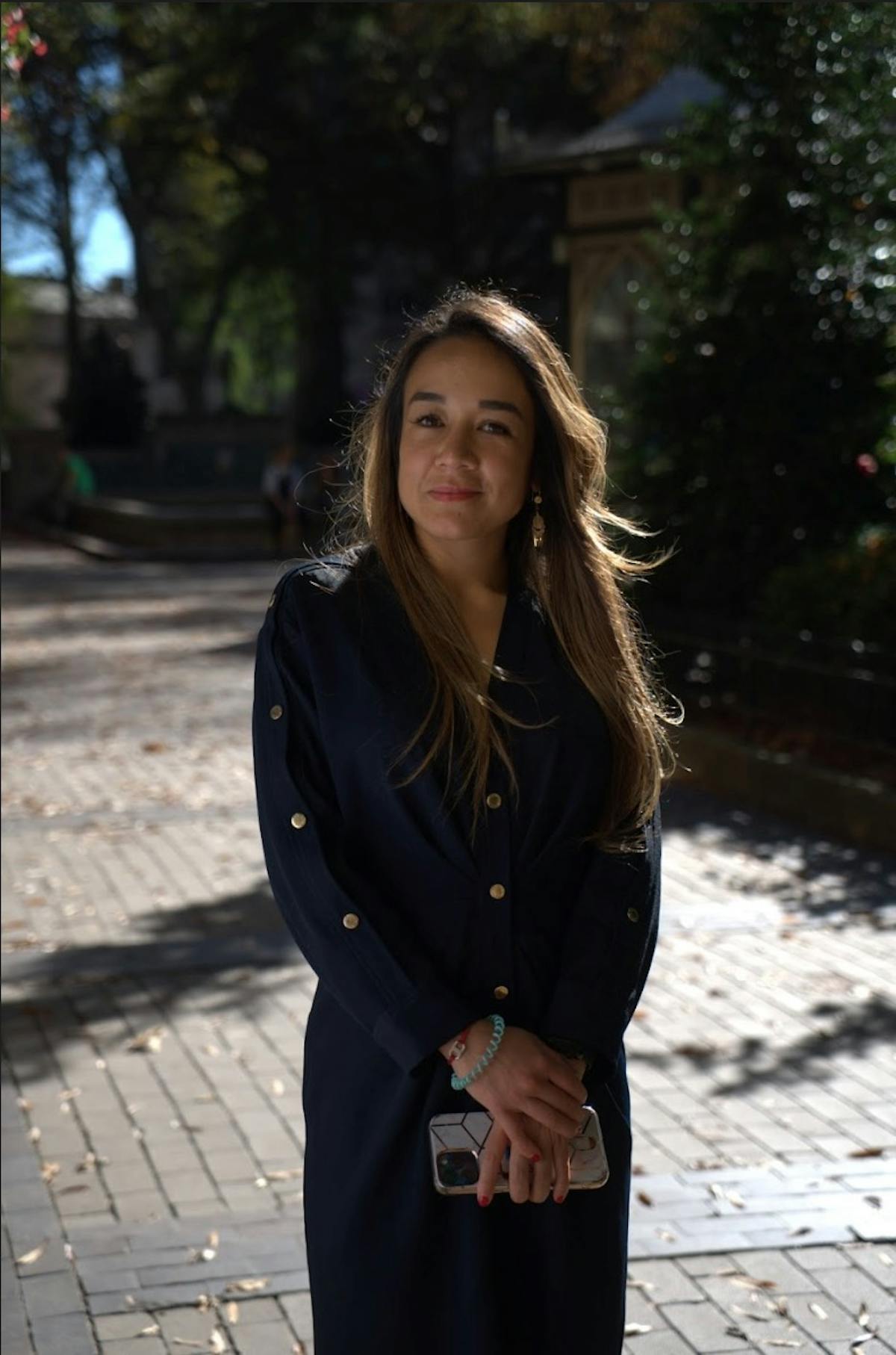 a woman standing on a sidewalk