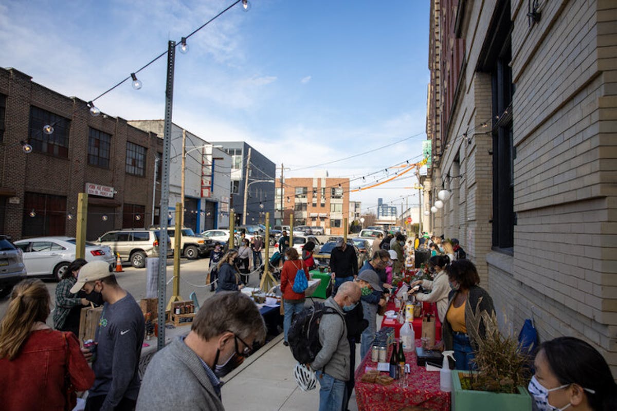 a group of people walking on a city street