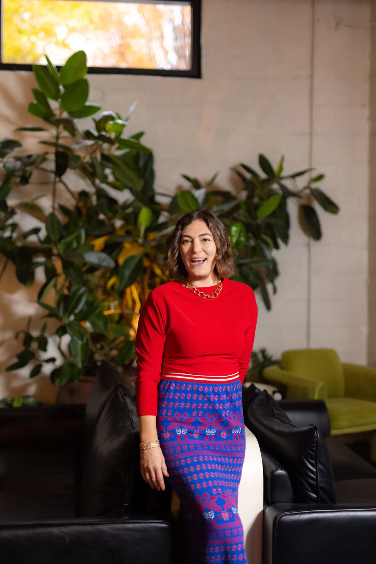 a woman in a red shirt and blue skirt