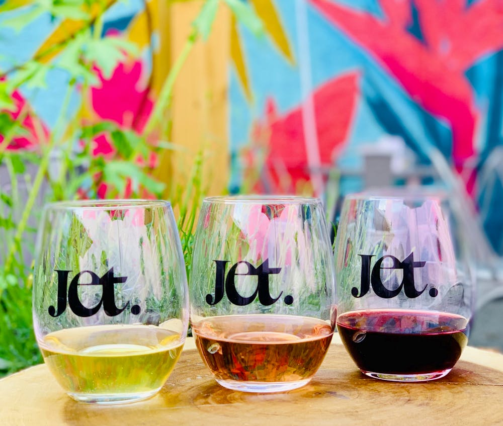 a colorful glass with a drink in front of a table