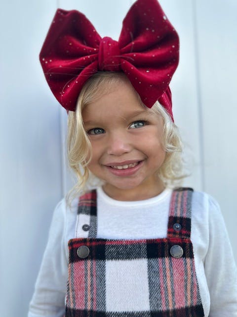 a little girl wearing a hat