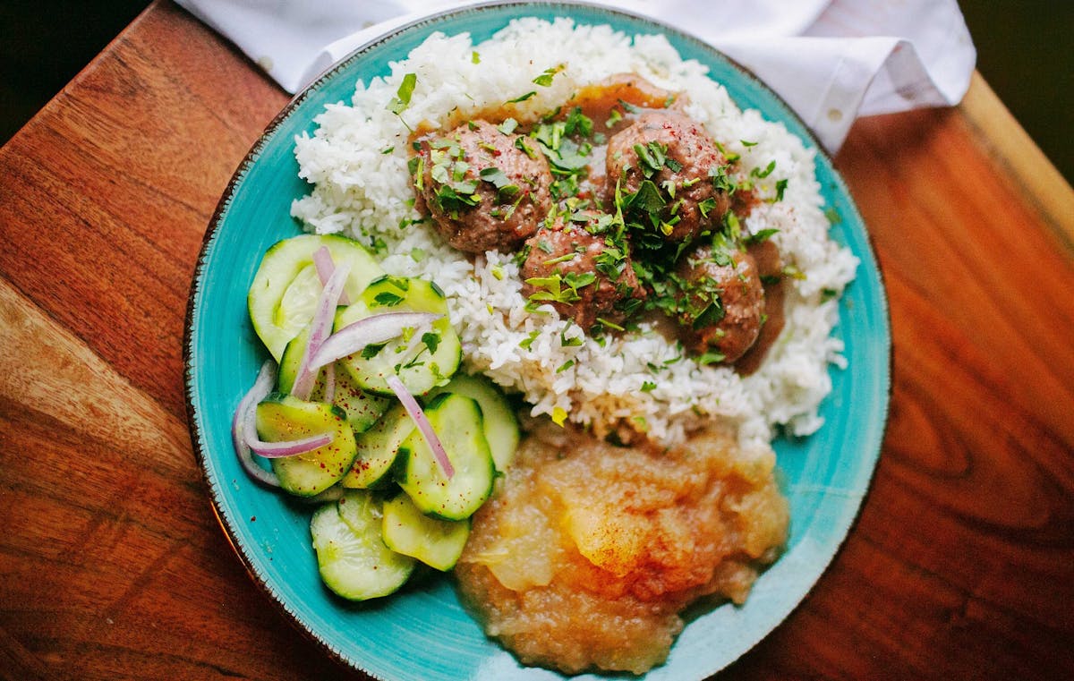 a plate of food sitting on top of a wooden table