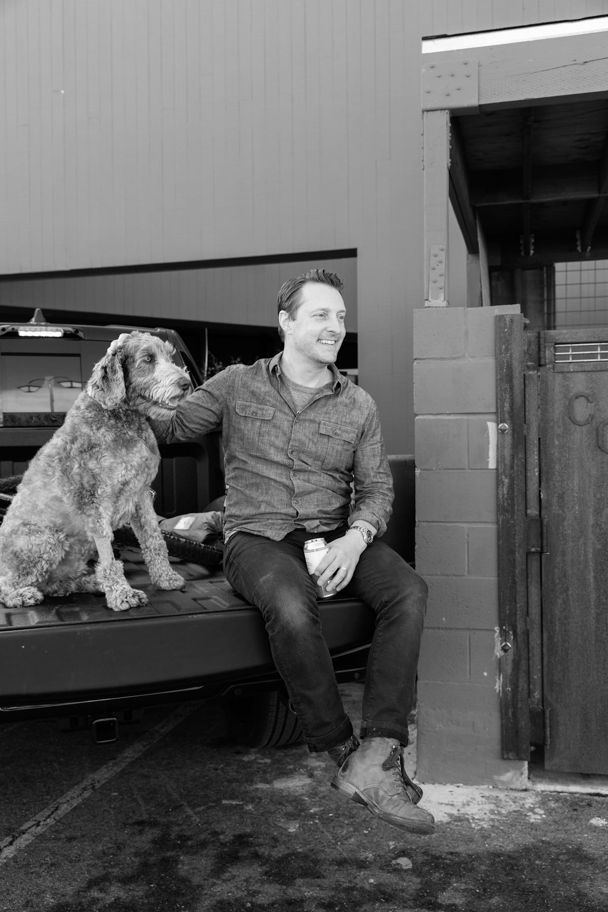 a man and a dog sitting in front of a building