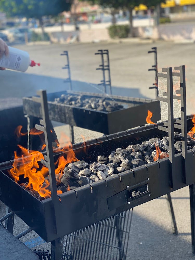  a close up of a grill with burning charcoal 