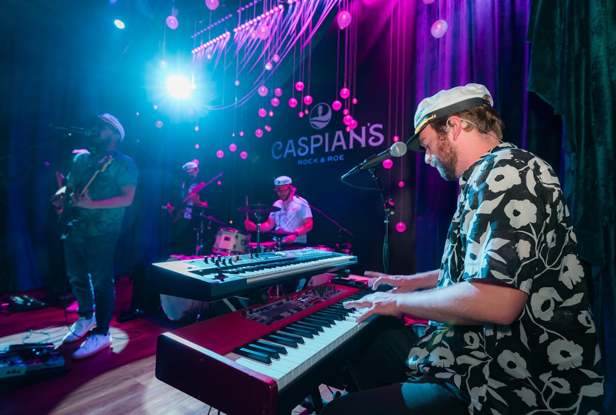 a man standing on a stage playing instruments