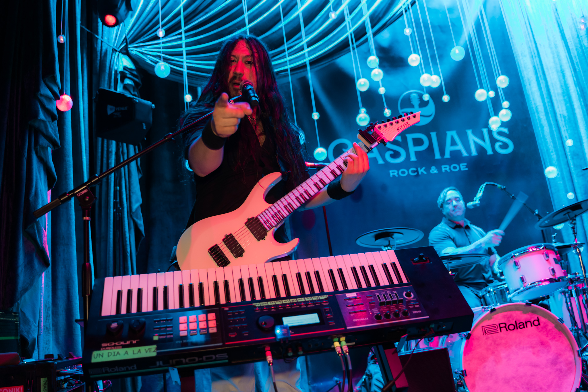 Gabriel from the band Neon Knights playing the electric guitar and piano at the same time at Las Vegas speakeasy Caspians