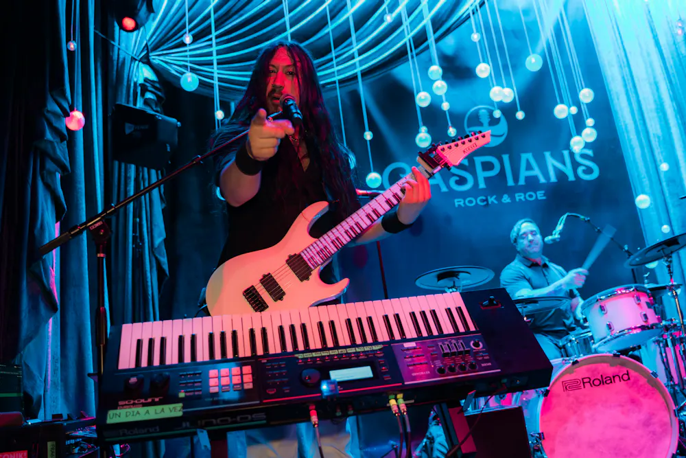Gabriel from the band Neon Knights playing the electric guitar and piano at the same time at Las Vegas speakeasy Caspians
