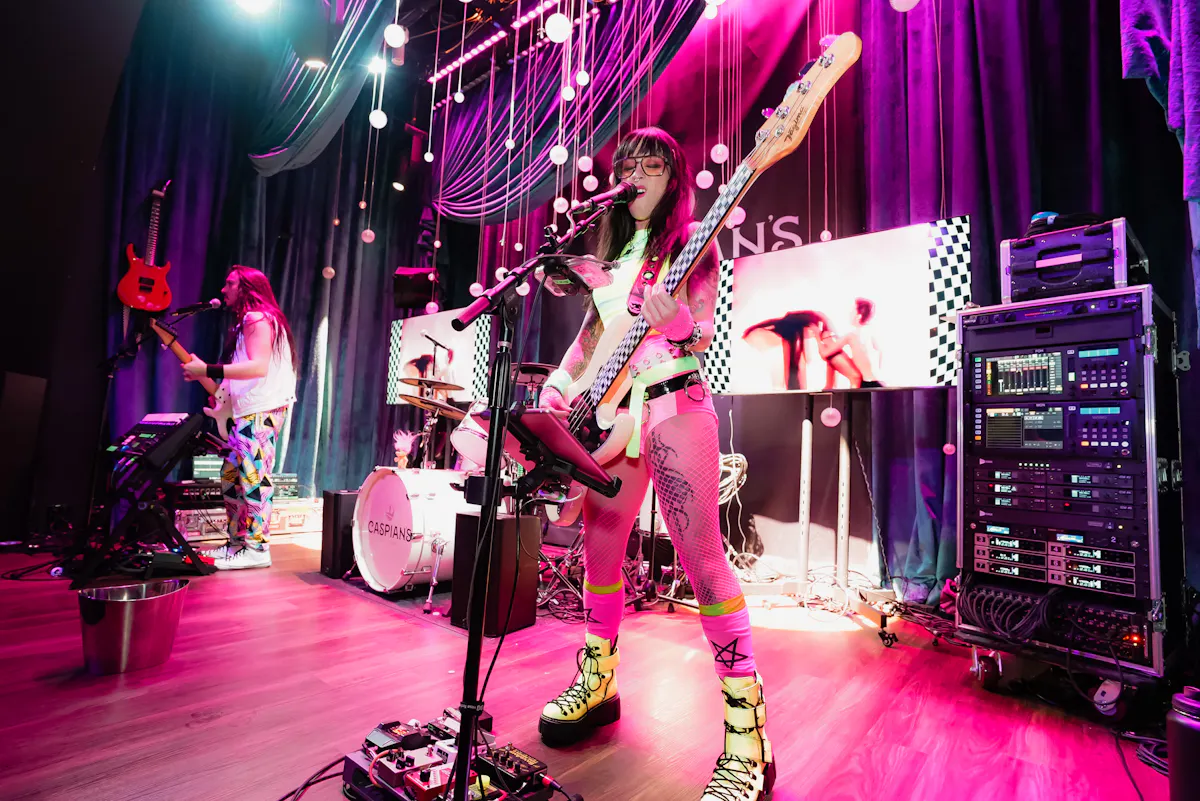 a woman playing a guitar on a stage