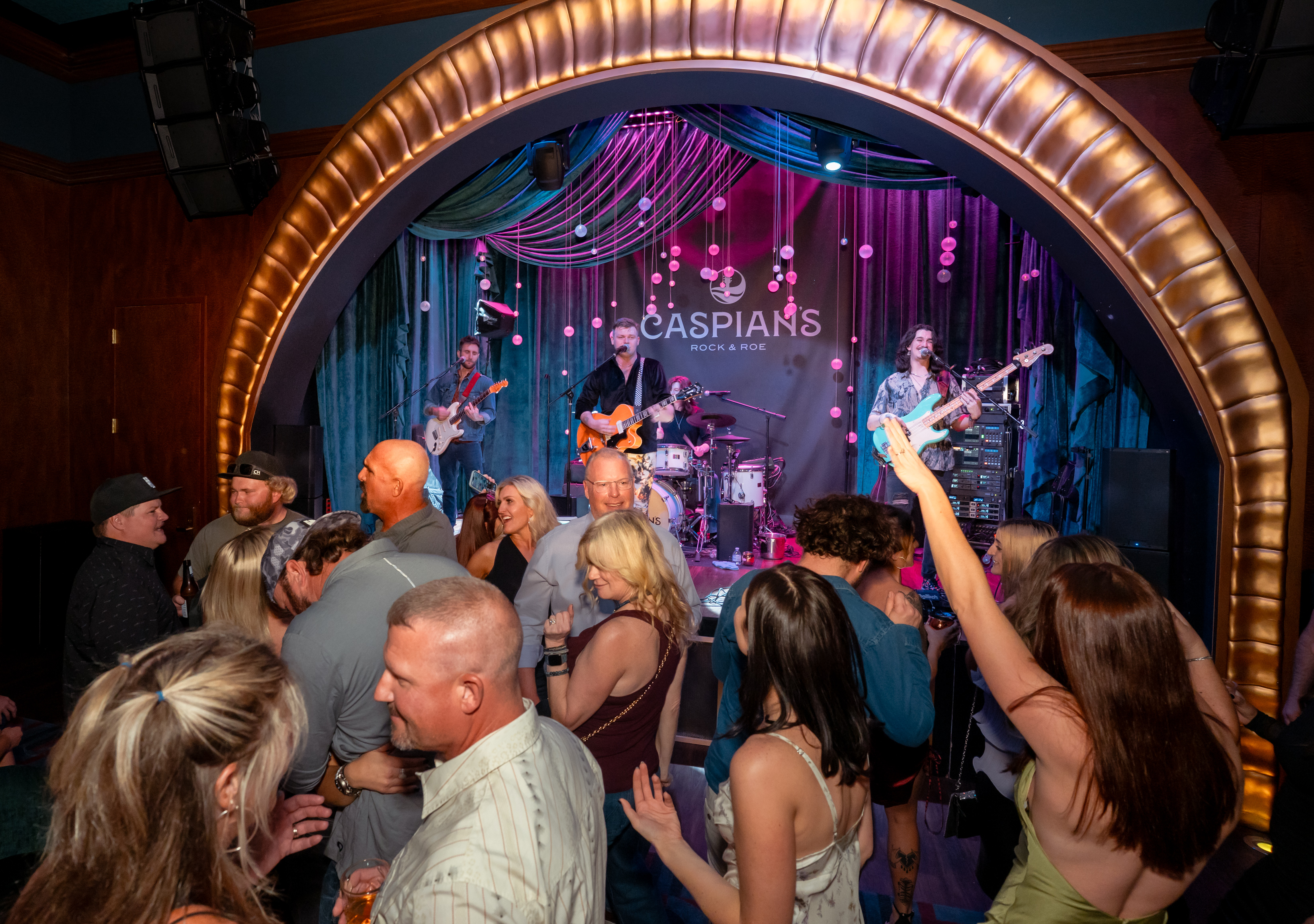 Band preforming inside Caspians Rock & Roe Speakeasy 