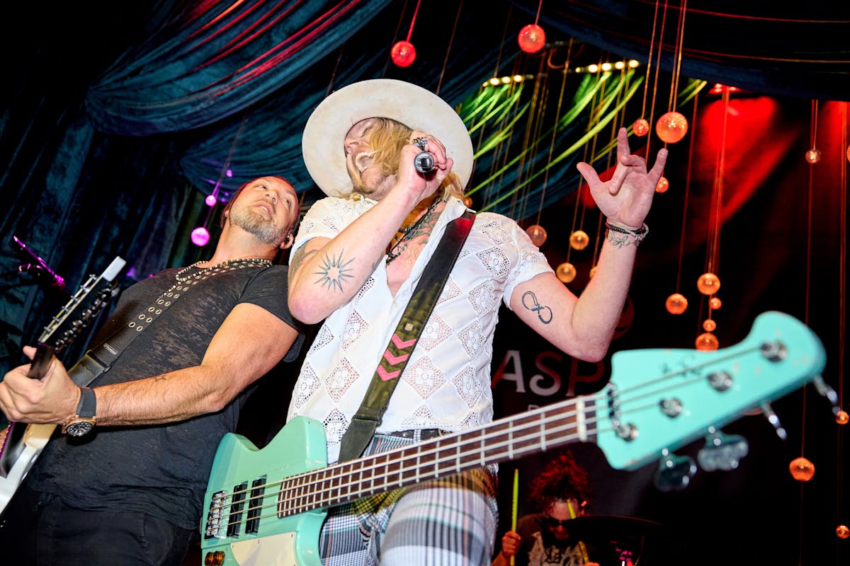 a man on a stage holding a guitar