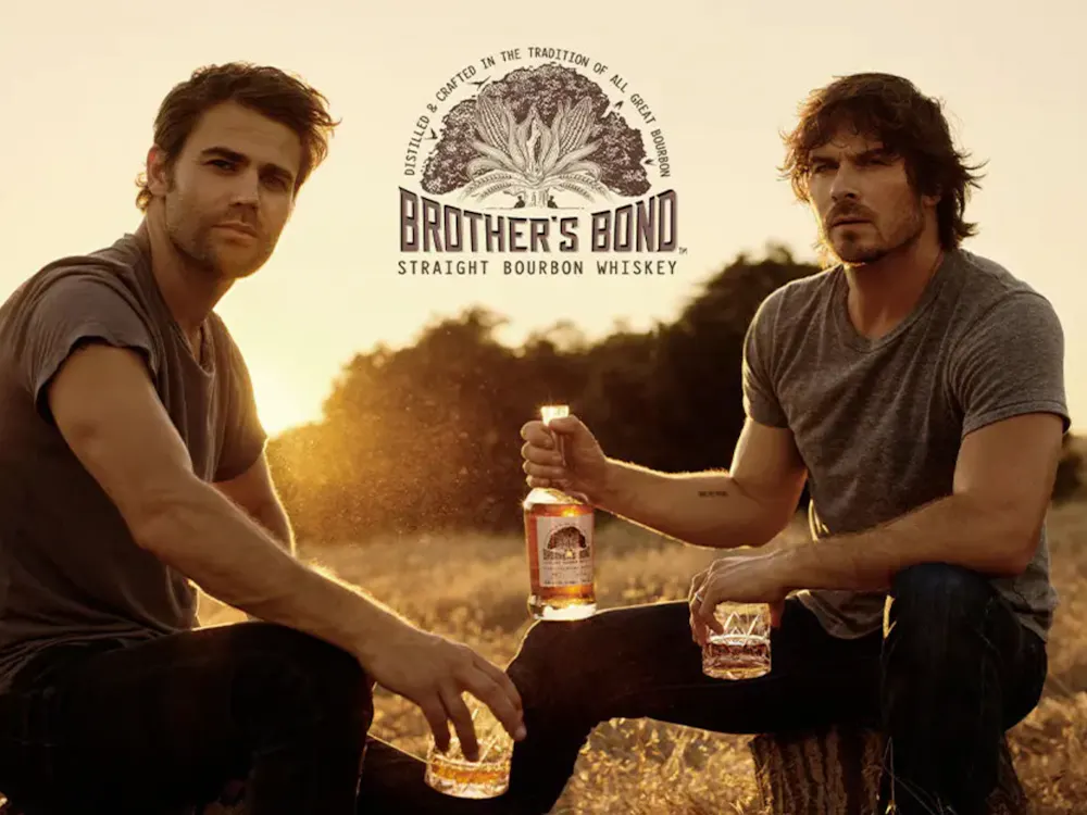 Ian Somerhalder and Paul Wesley posing with their brothers bond bourbon