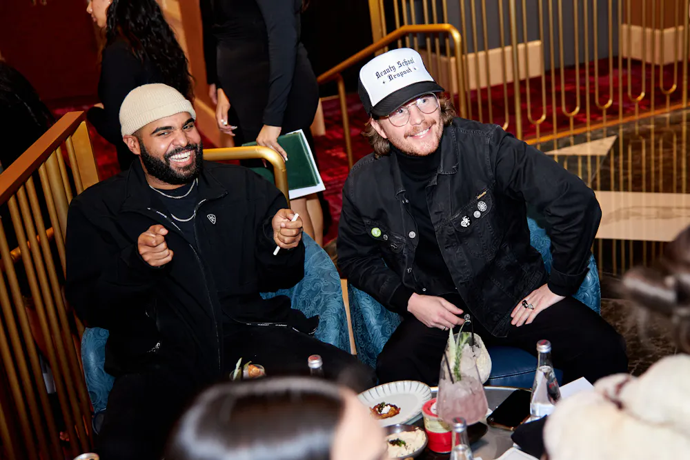 two men cheering on teams at caviar lounge