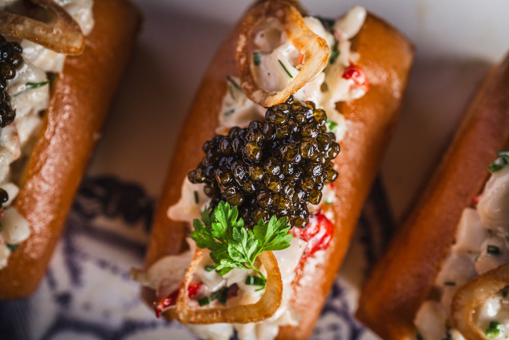 Las Vegas caviar bar, caspians, showing a pic of their lobster rolls topped with caviar