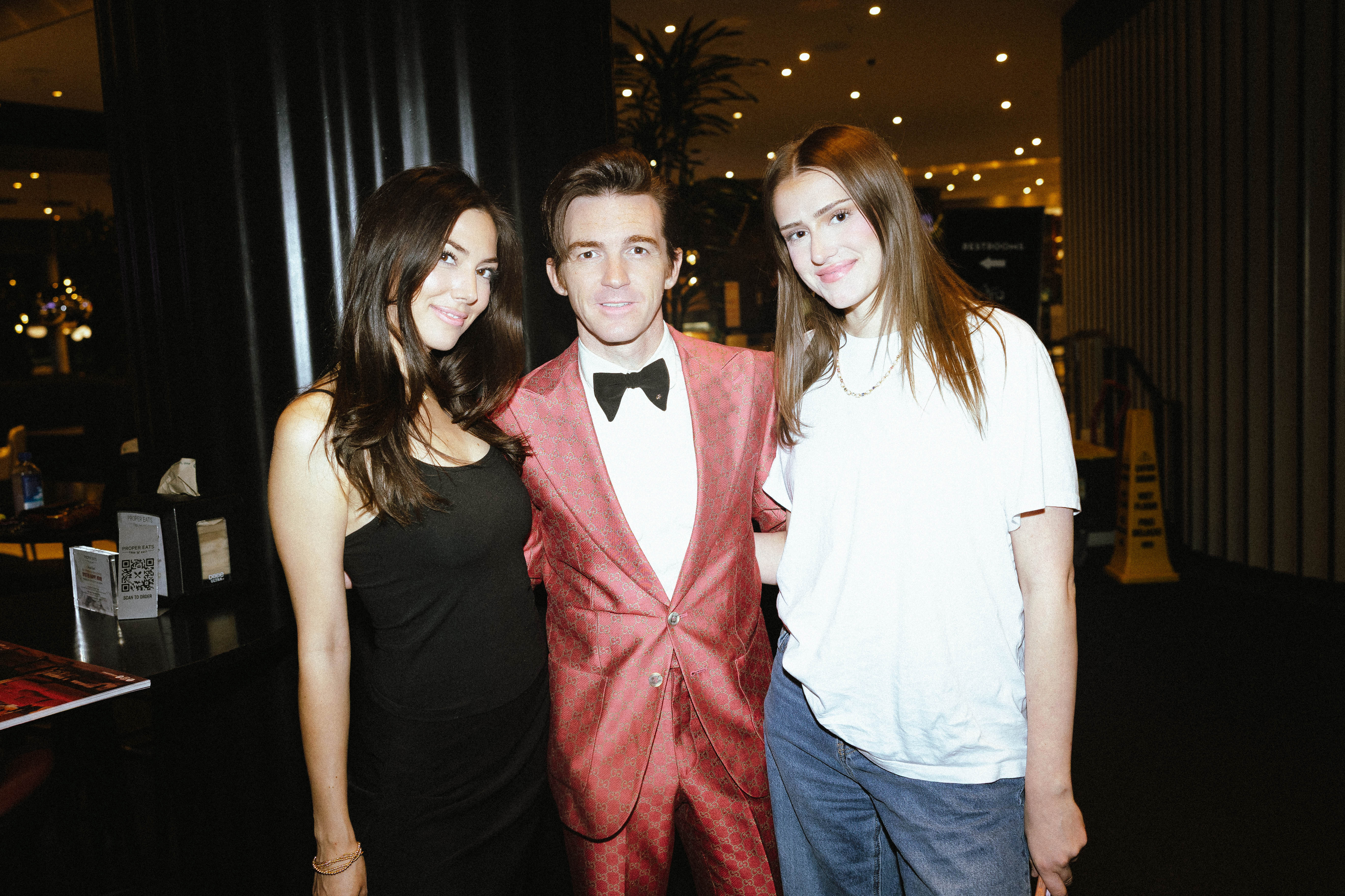 two girls pictured with Drake Bell after the performing at Las Vegas speakeasy