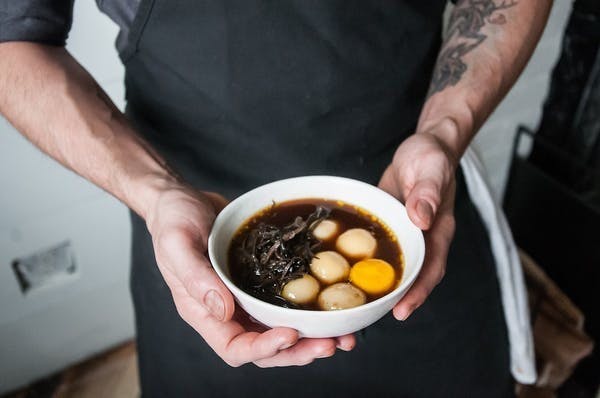 a man holding a bowl of food