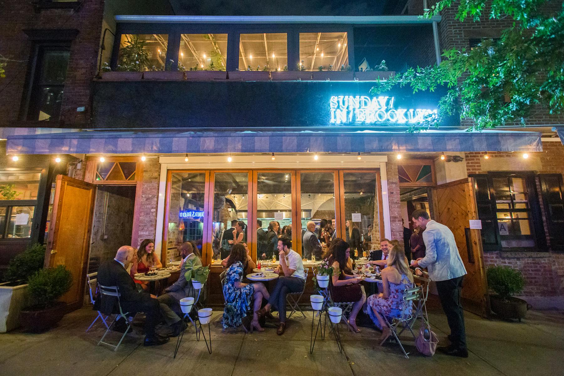 a group of people sitting in front of a store