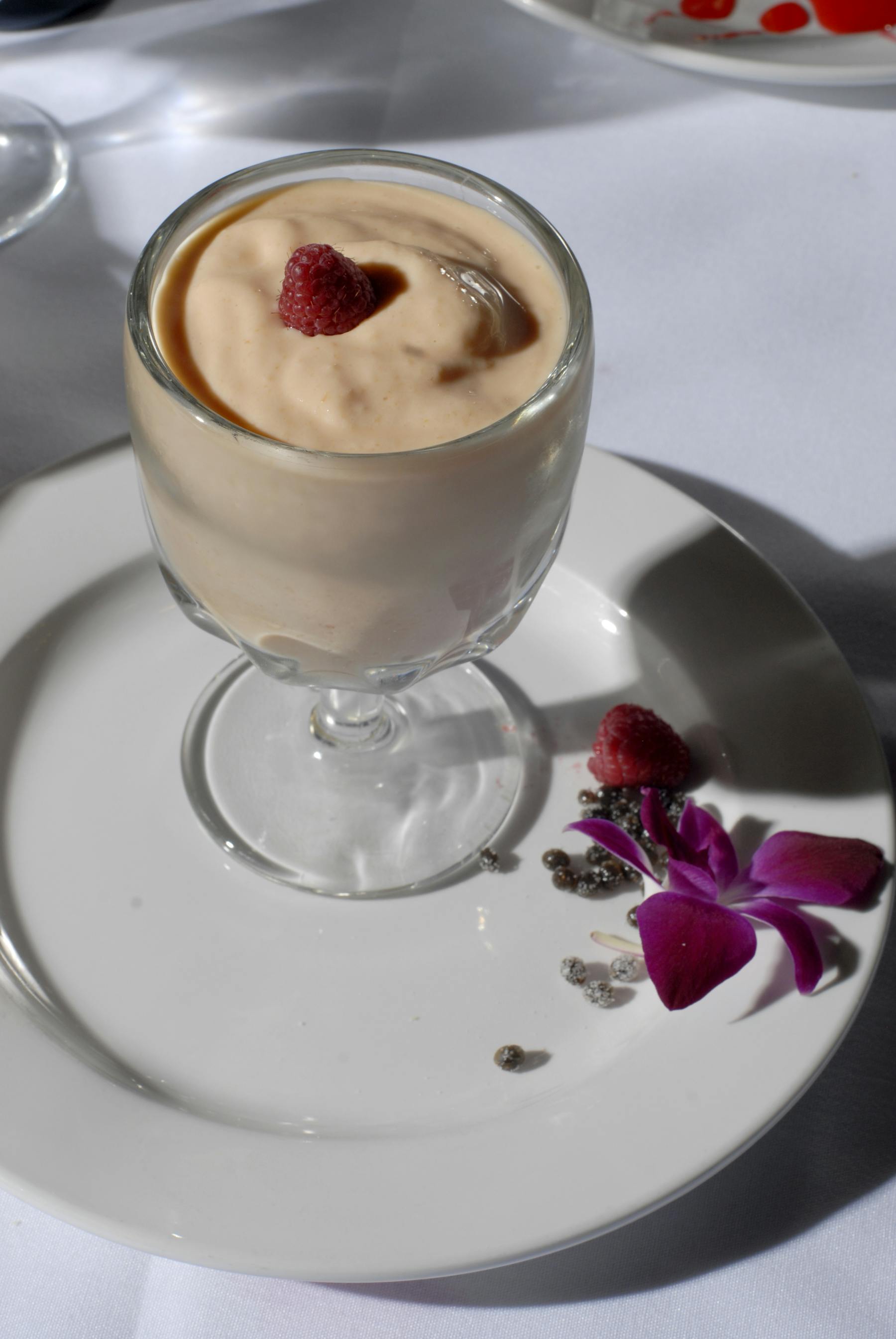 a dessert on a plate next to a cup of coffee
