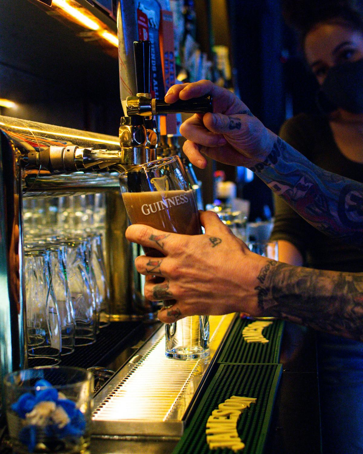 a man holding a beer pint