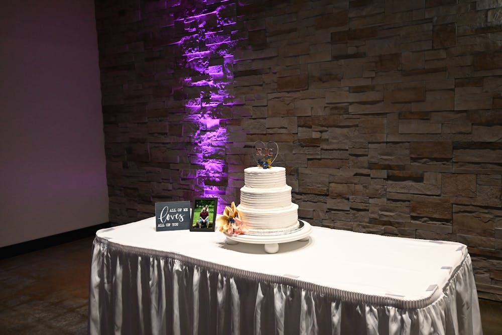 a couple cutting a wedding cake