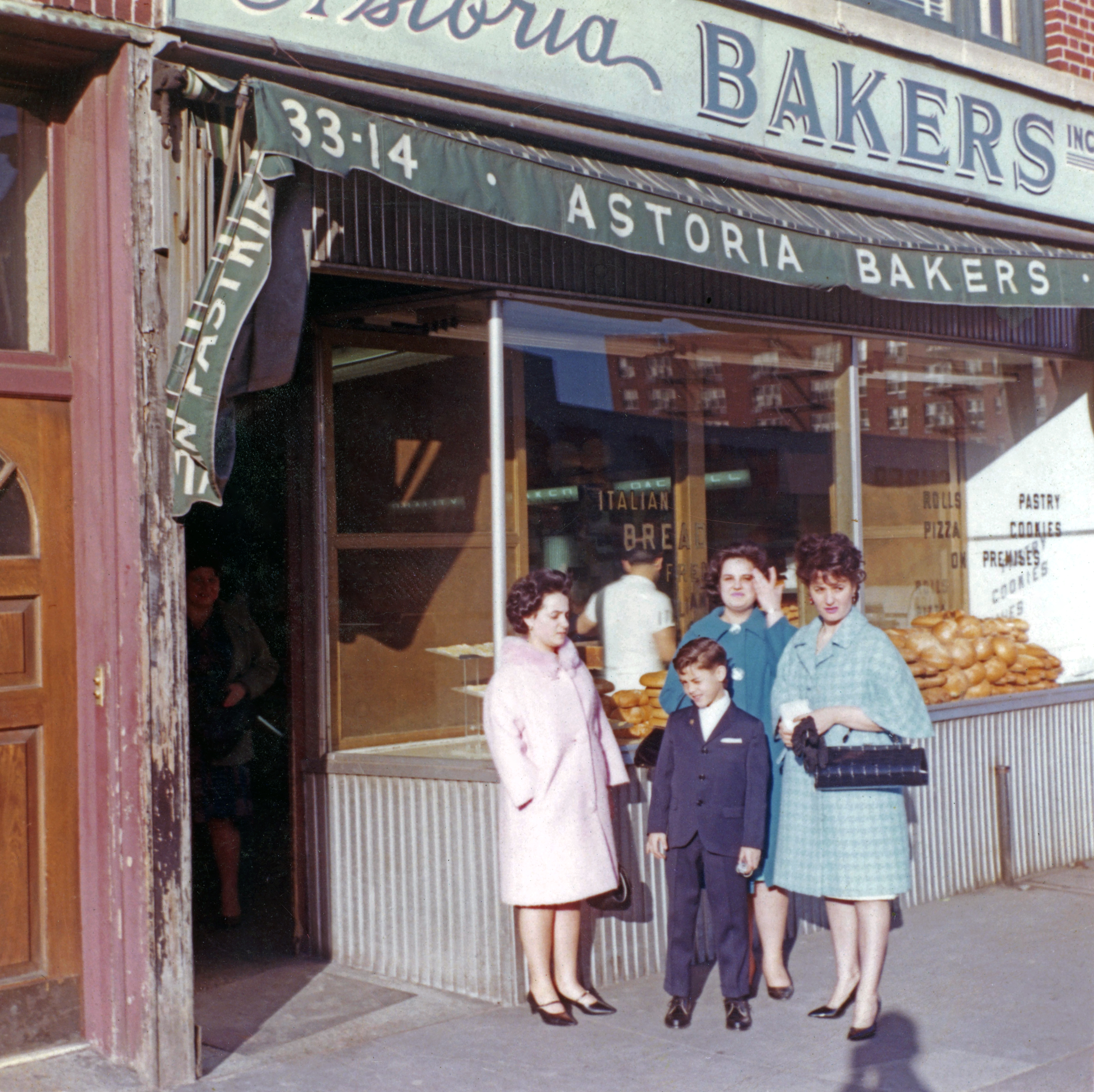 a group of people walking in front of a store